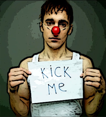 Man with clown nose, sign saying Kick Me